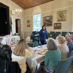 Women gathered around table in community meeting