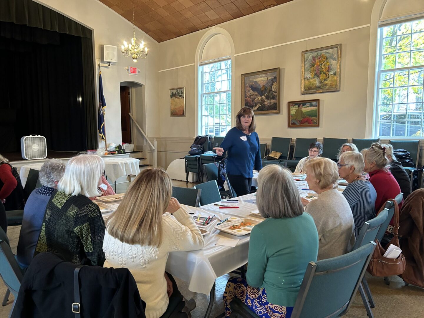 Women gathered around table in community meeting