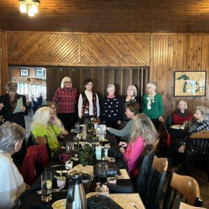 Women gathered around long dining table