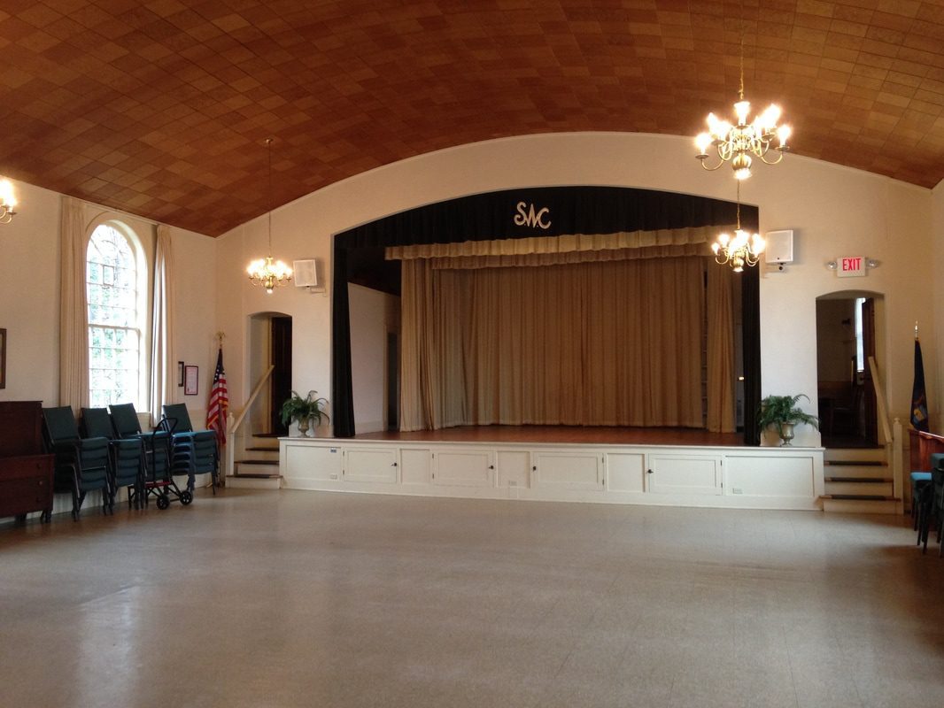 Community hall with stage and curtains