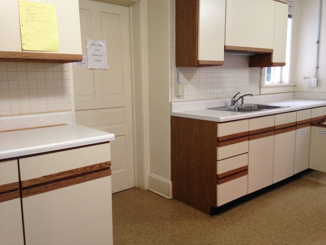 Simple kitchen with white cabinets and sink.