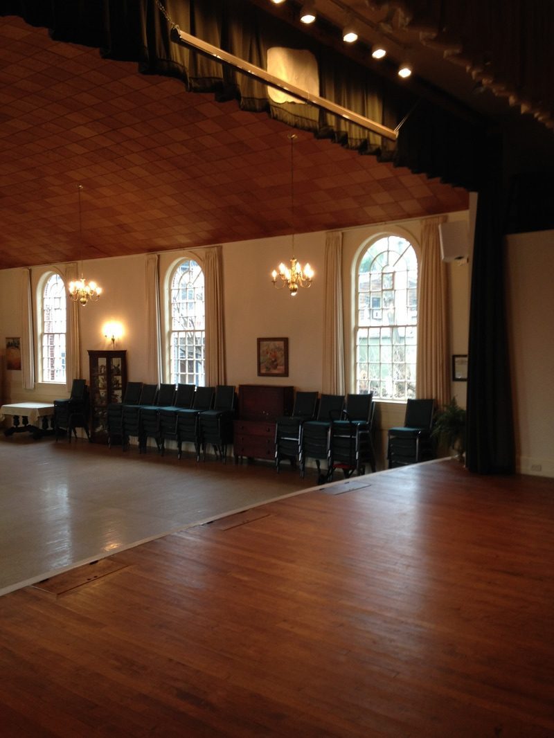 Empty hall with wooden floor and windows