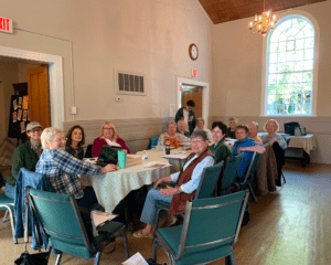 Group seated around table in church hall