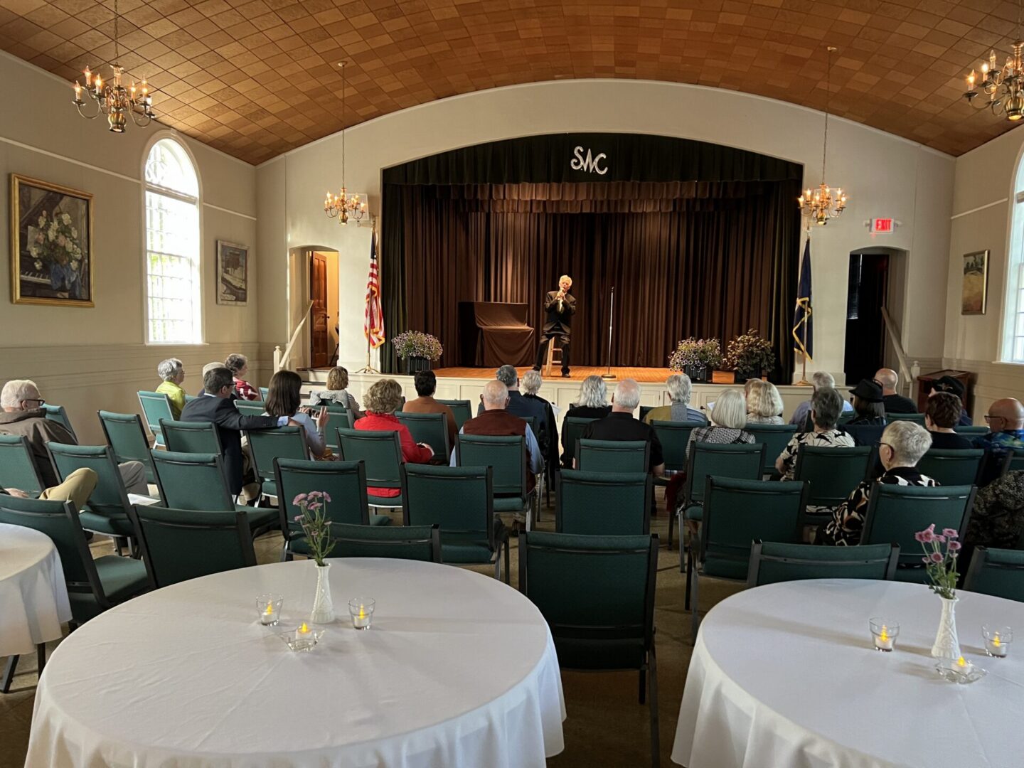 Audience seated listening to speaker on stage