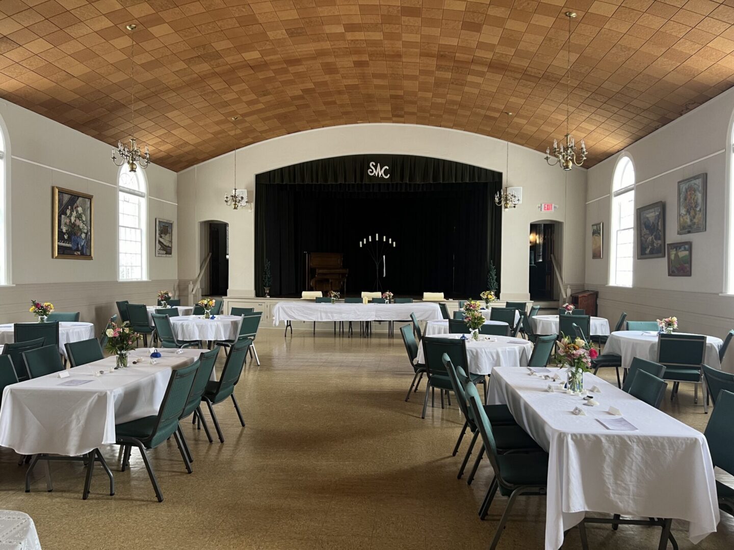 Banquet hall with white tablecloths and stage