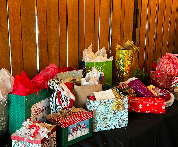 Assorted wrapped Christmas gifts on table