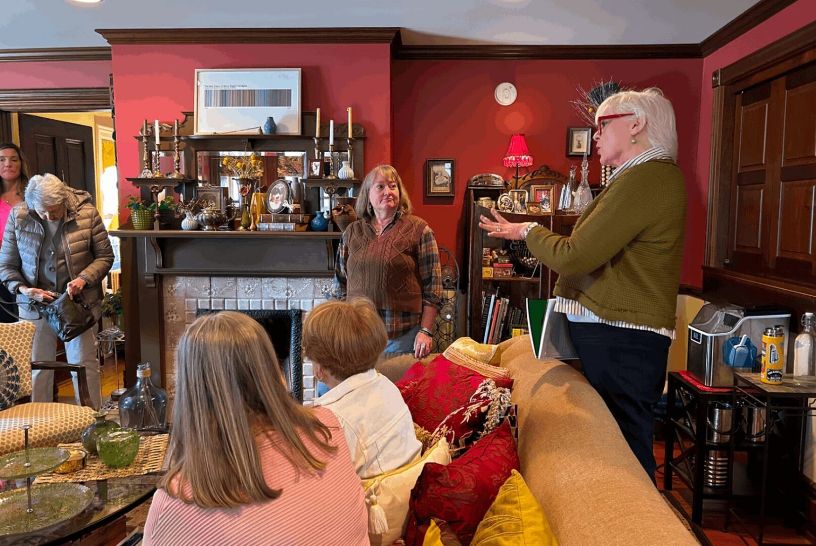 People gathered in cozy red living room