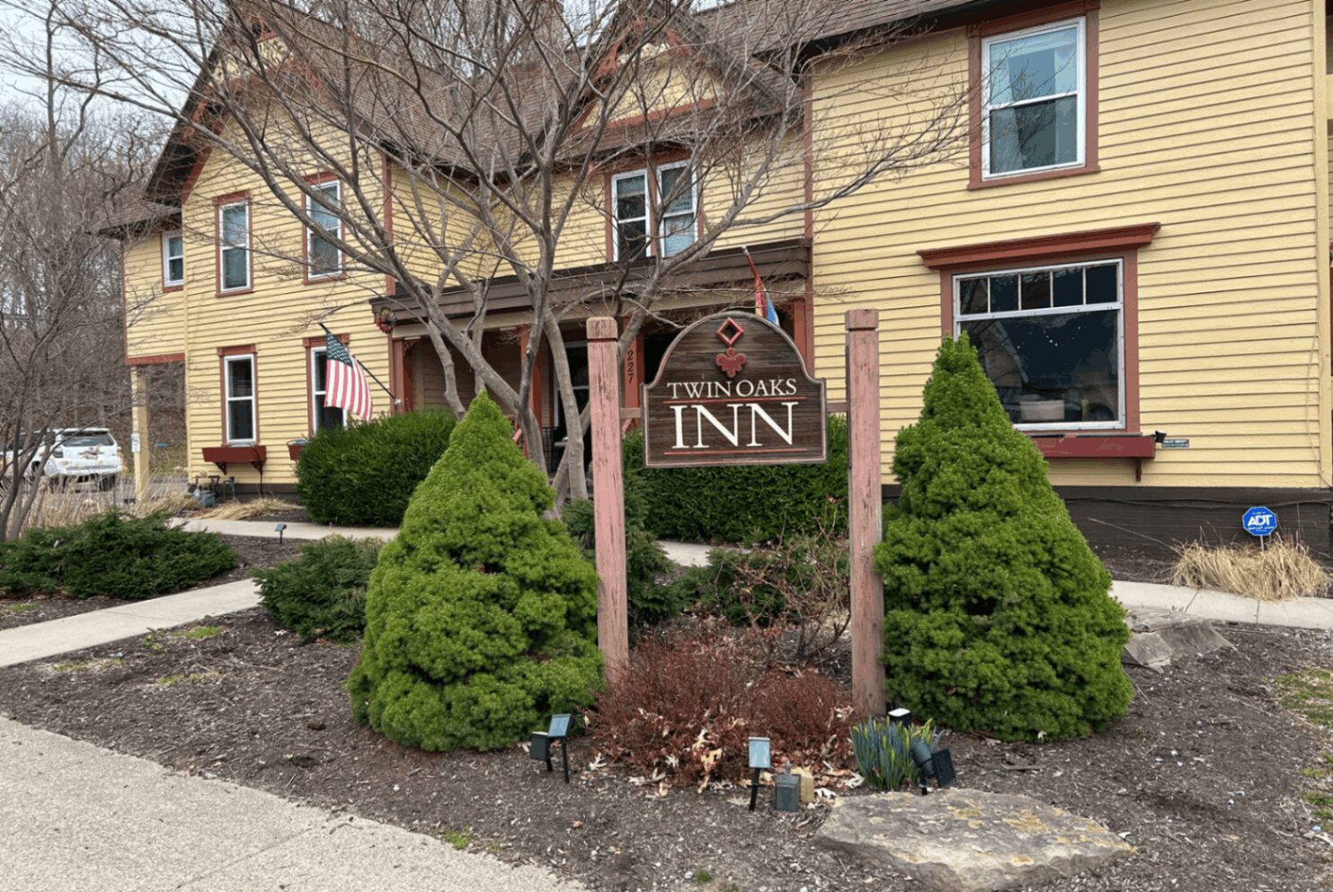 Twin Oaks Inn sign outside yellow building