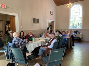 Group seated around table in community room