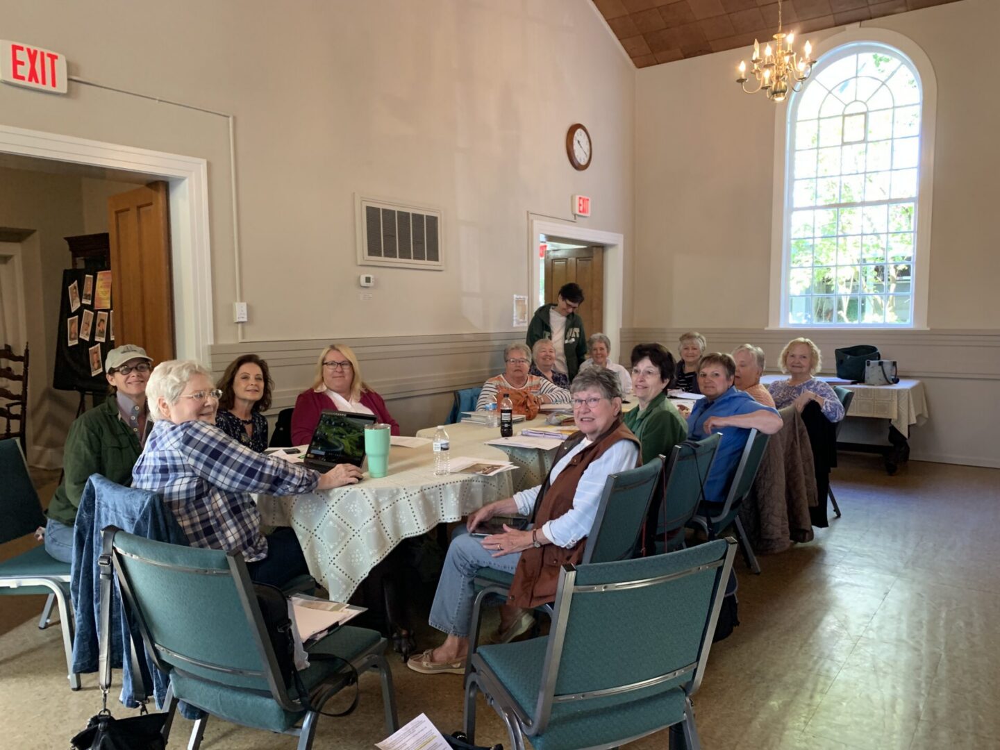 Group seated around table in community room