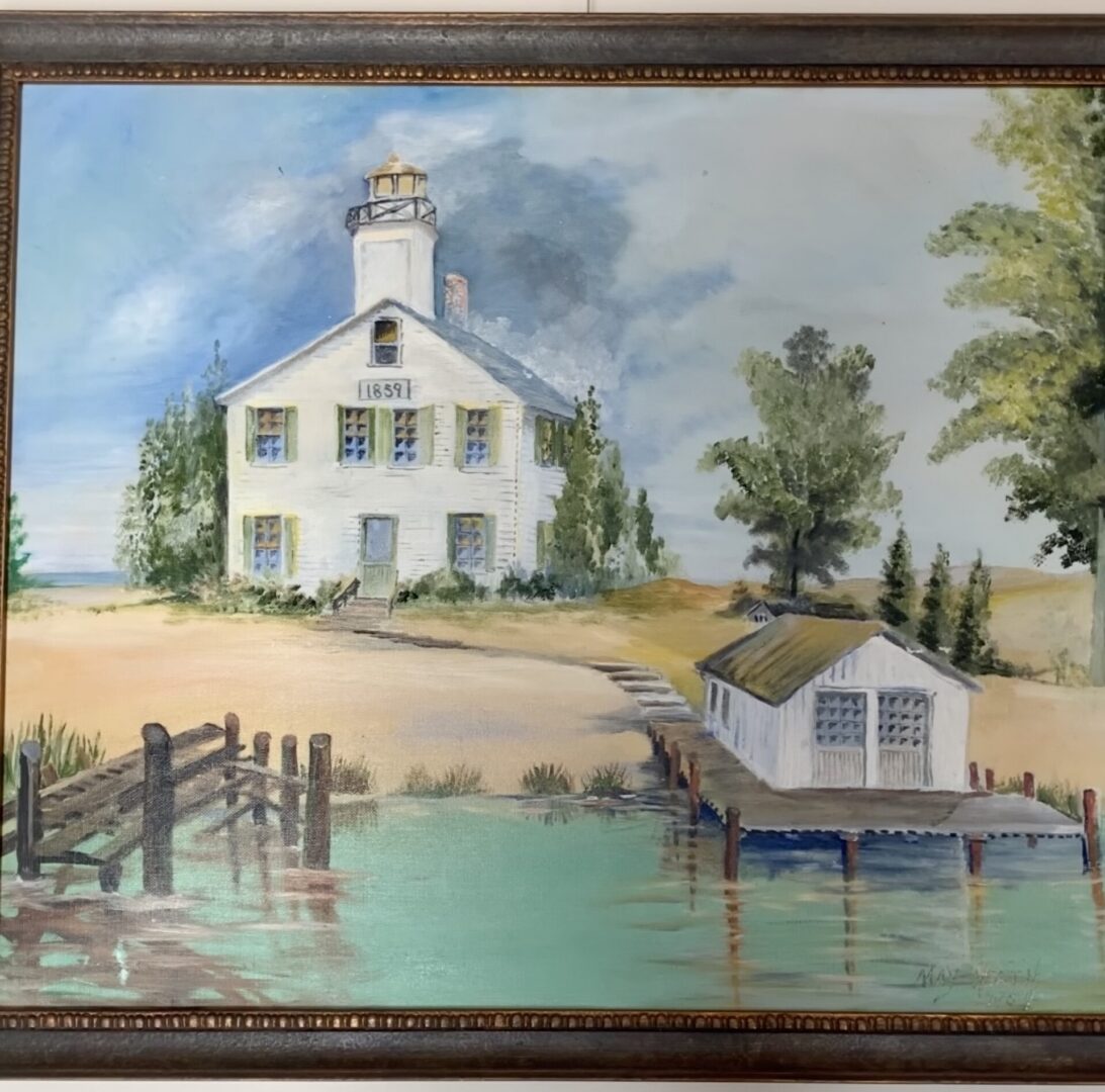 Framed coastal painting of lighthouse and boathouse